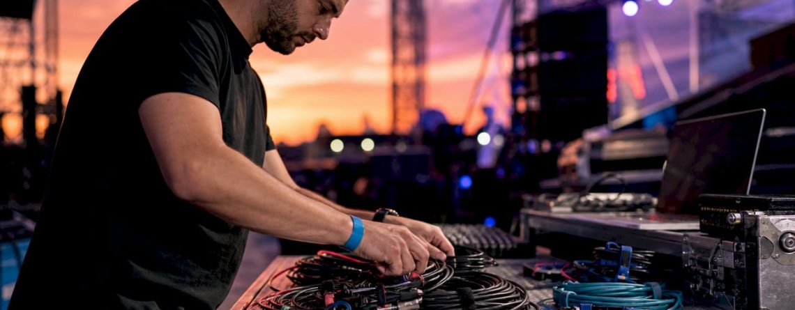 DJ ruimt kabels netjes op in de studio