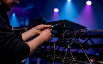 Handen maken de verbinding van een DMX XLR-kabel met een lichtcontroller