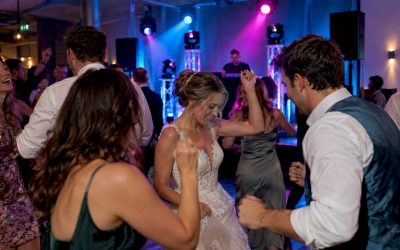 Gasten dansen onder de feestverlichting op een bruiloft